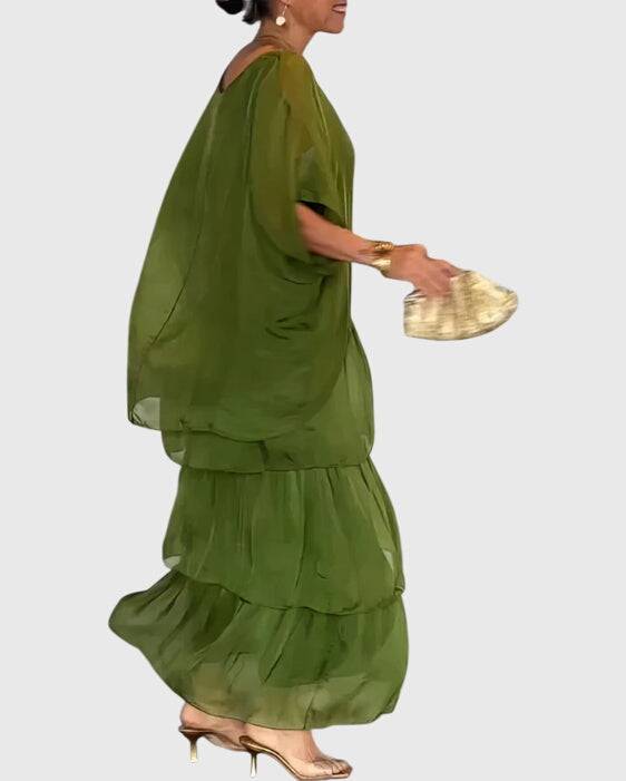 Long flowing elegant dress by Emma & Rose Cape Town, Susan™, featuring a graceful, floor-length design with delicate fabric details.