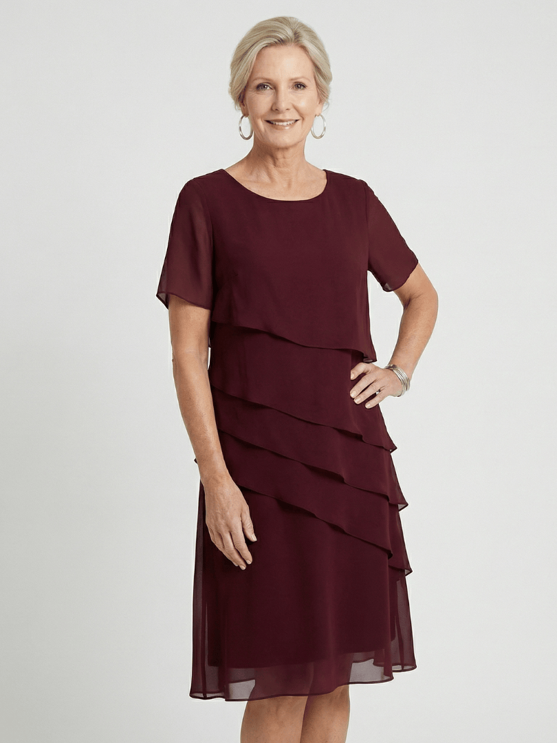 Emma & Rose Cape Town Orson™ contour knee-length dress in black, showcasing a fitted silhouette and elegant design.