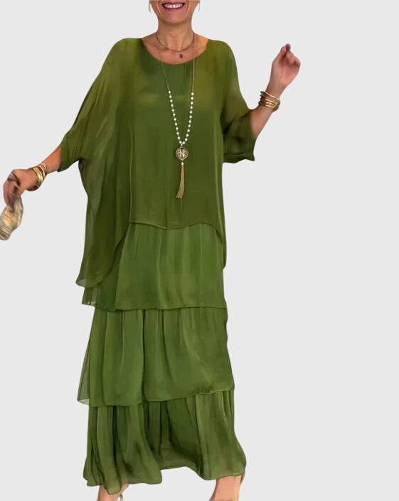 Elegant long flowing dress by Emma & Rose Cape Town, featuring a graceful silhouette and intricate fabric details.