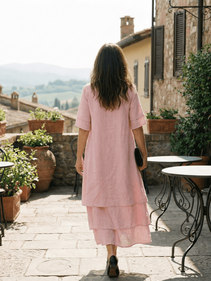 Emma & Rose Cape Town Belen™ soft layered dress with flowing fabric and elegant design, displayed on a hanger.