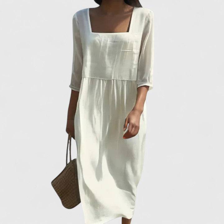Elegant Delyshann™ dress by Emma & Rose Cape Town, shown in a flowing fabric with intricate detailing and a sophisticated silhouette.