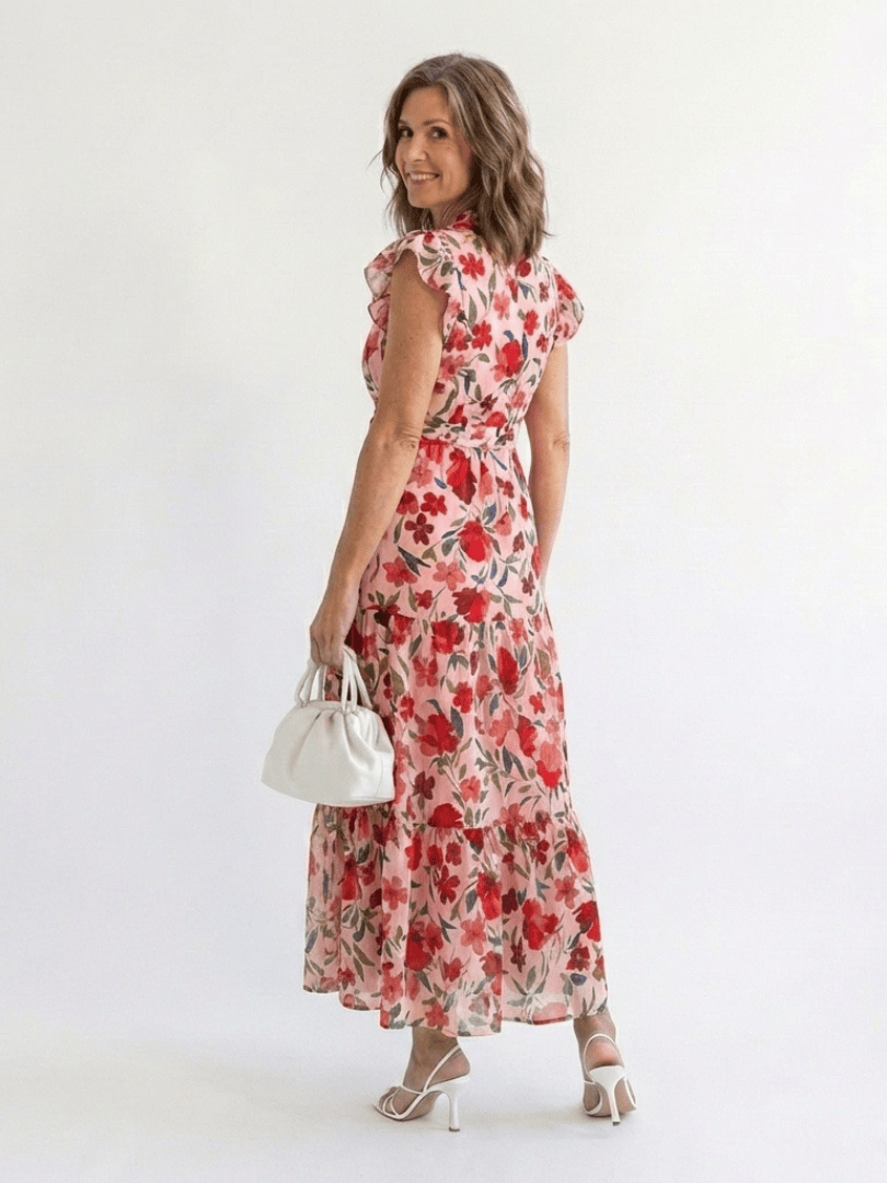 Lila™ V-neck tiered midi dress by Emma & Rose Cape Town, featuring flowing fabric and layered design, displayed on a mannequin.
