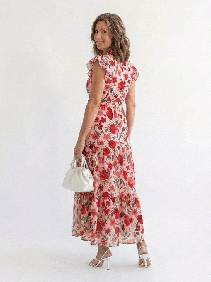 Lila™ V-neck tiered midi dress by Emma & Rose Cape Town, featuring flowing fabric and layered design, displayed on a mannequin.