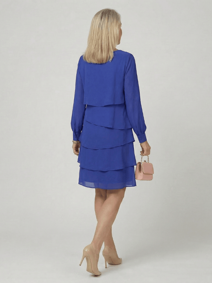Kirax™ layered knee-length dress by Emma & Rose Cape Town featuring a stylish, flowing design with layered fabric and knee-length cut.