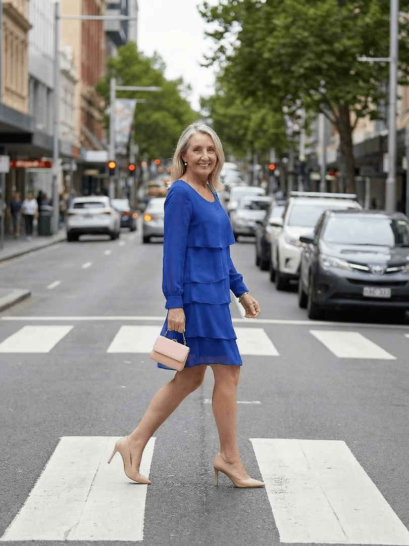Kirax™ layered knee-length dress by Emma & Rose Cape Town, featuring a flowing design and elegant fabric with a fitted waist.