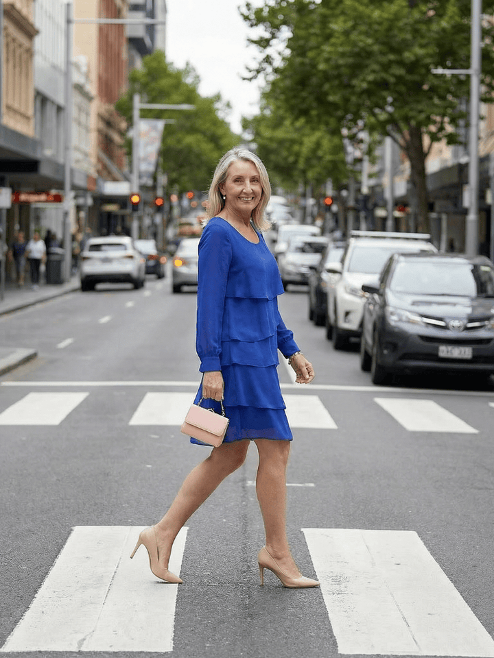 Kirax™ layered knee-length dress by Emma & Rose Cape Town, featuring a flowing design and elegant fabric with a fitted waist.