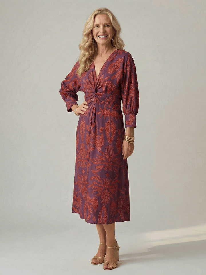 Lune™ Natural Wrap Midi Dress by Emma & Rose Cape Town, featuring flowing fabric and elegant design, displayed on a hanger.