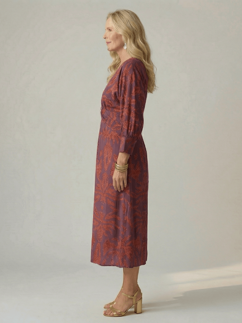 Lune™ natural wrap midi dress by Emma & Rose Cape Town, featuring flowing fabric and elegant design, worn by a model.