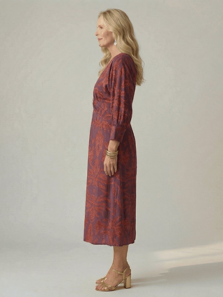 Lune™ natural wrap midi dress by Emma & Rose Cape Town, featuring flowing fabric and elegant design, worn by a model.