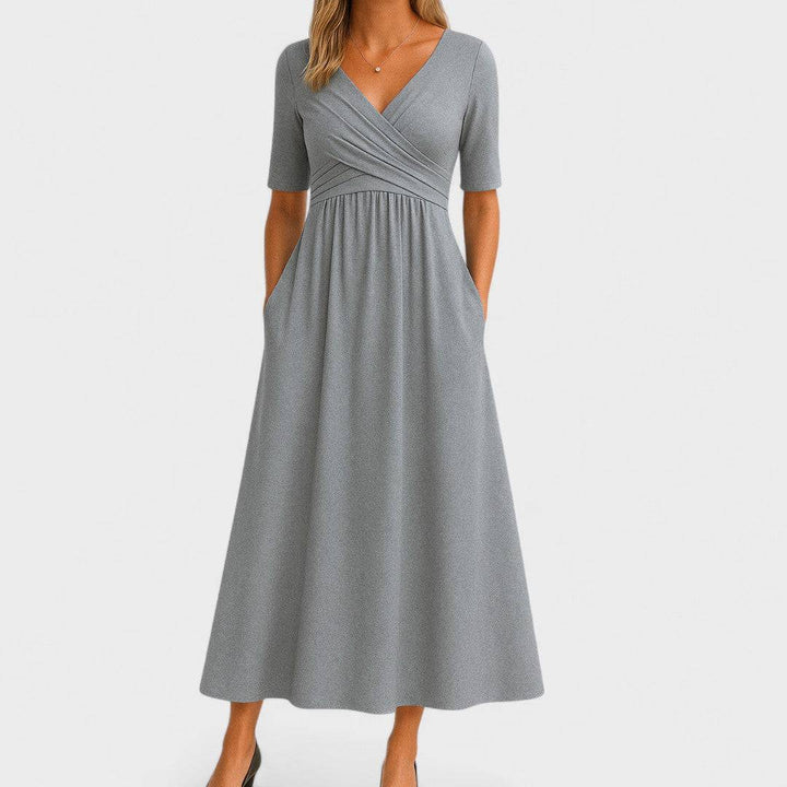 Elegant Phoebe™ midi dress by Emma & Rose Cape Town, featuring a flowing silhouette and stylish design, displayed on a hanger.