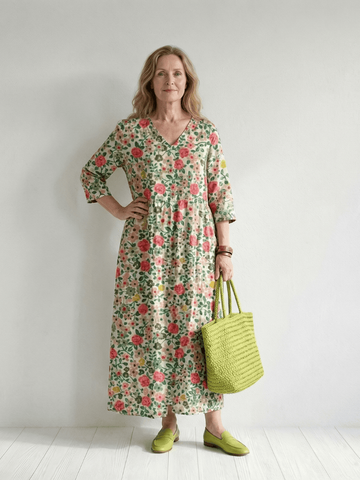Emma & Rose Cape Town Colin™ Scatter Flower Midi Dress with a floral pattern and flowing fabric, displayed on a hanger.