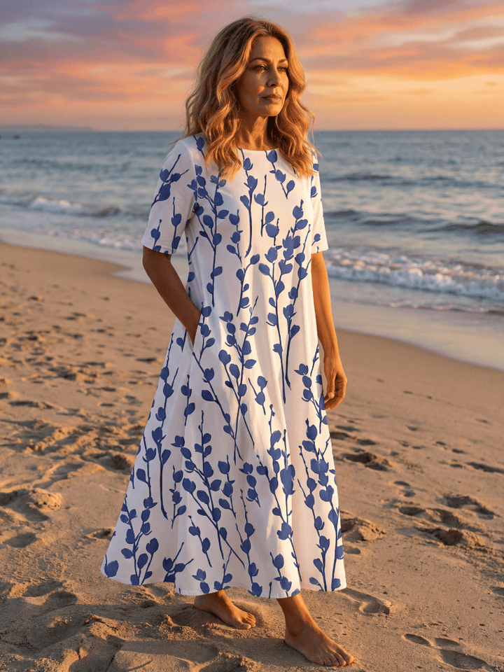 Miles™ Floral Midi Dress by Emma & Rose Cape Town, featuring a vibrant floral pattern and flowing midi length, displayed on a hanger.