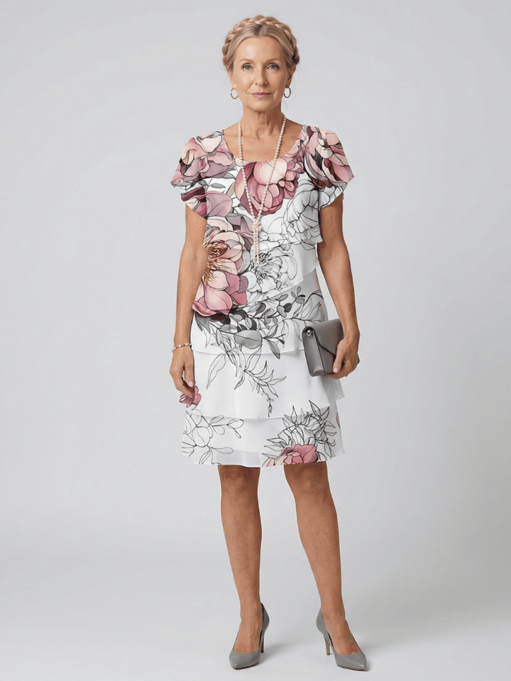 Kualani floral knee-length dress by Emma & Rose Cape Town featuring a vibrant floral pattern and a flowing silhouette.