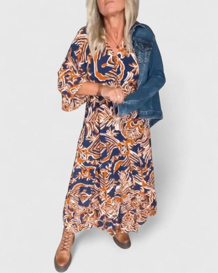 Emma & Rose Cape Town Julee™ Maxi Dress in elegant, flowing fabric with a sophisticated design and detailed neckline.