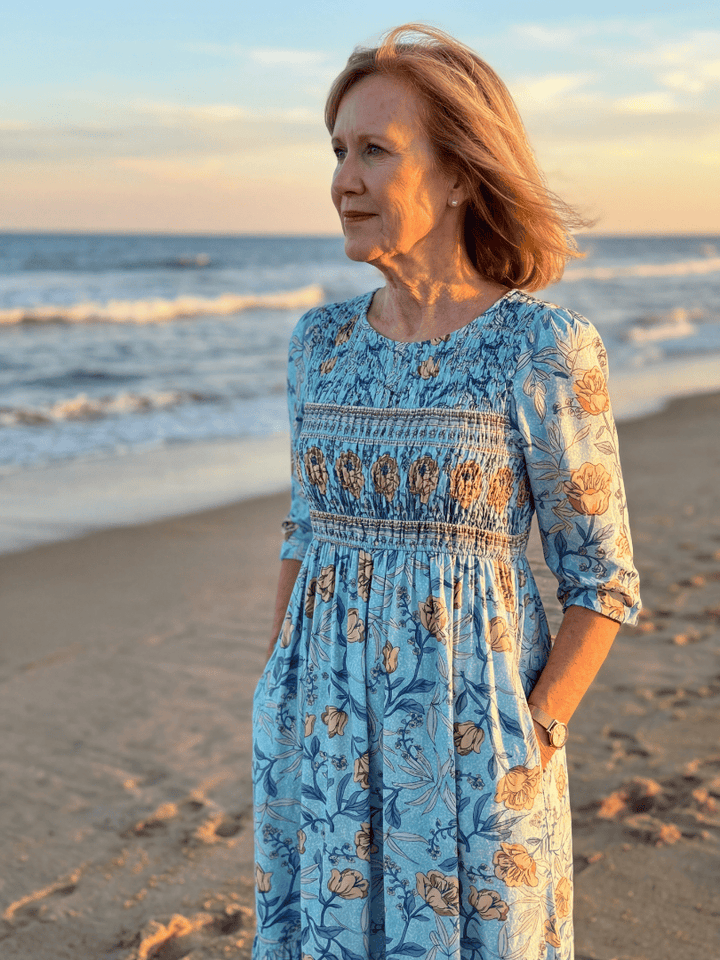 Halia Meadow Gather Midi Dress by Emma & Rose Cape Town, featuring a flowing fabric, floral pattern, and midi length on a model.