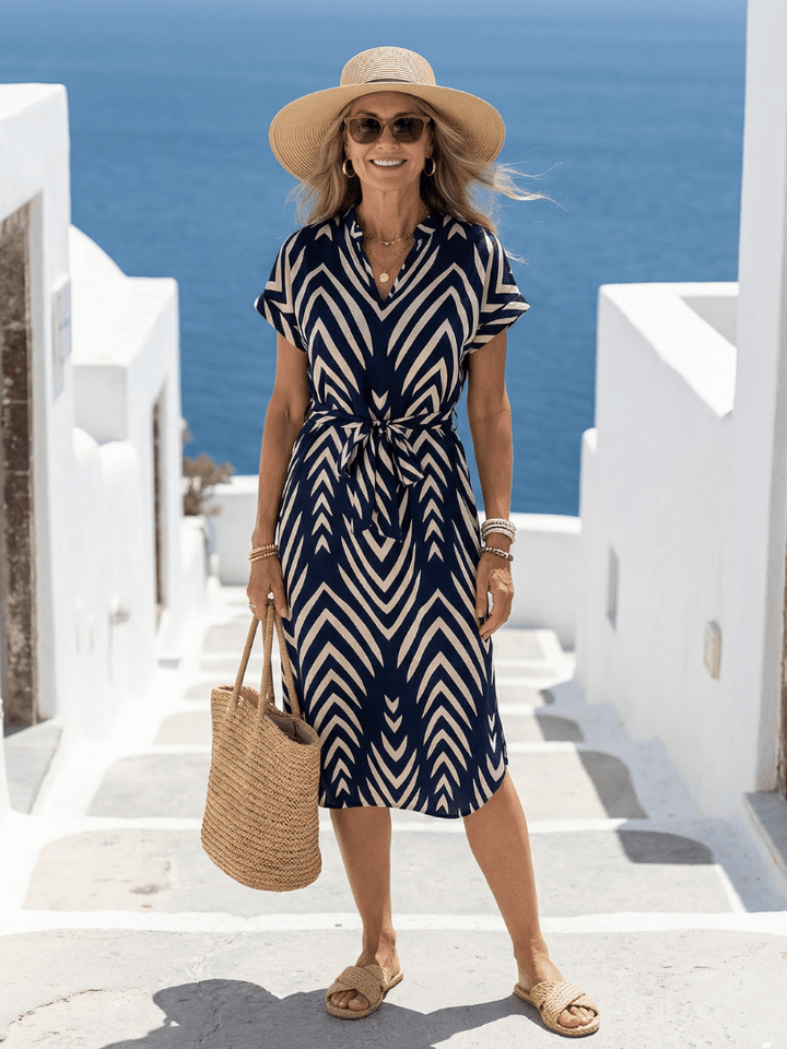 Emma & Rose Cape Town Ora™ Fit Patterned Midi Dress with colorful floral design and fitted silhouette on model.