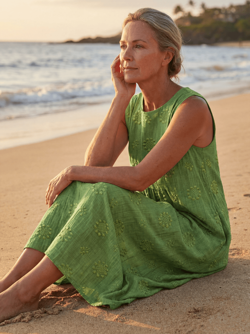 Kapua™ Garden Texture Midi Dress by Emma & Rose Cape Town, featuring floral pattern and flowing fabric, displayed on a hanger.
