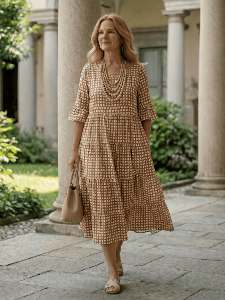 Emma & Rose Cape Town Arlo™ Dot Tiered Midi Dress with polka dot pattern and flowing tiered skirt, front view.