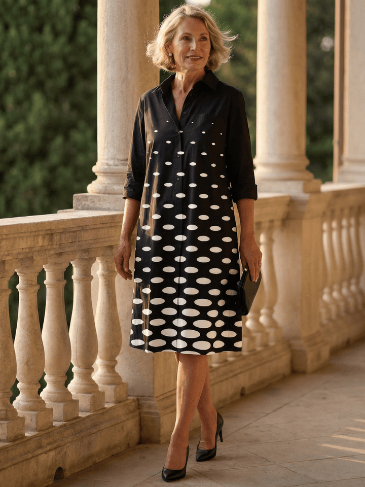 Faye™ Evening Walk Dress by Emma & Rose Cape Town, elegant navy-blue dress with flowing fabric and V-neck design.