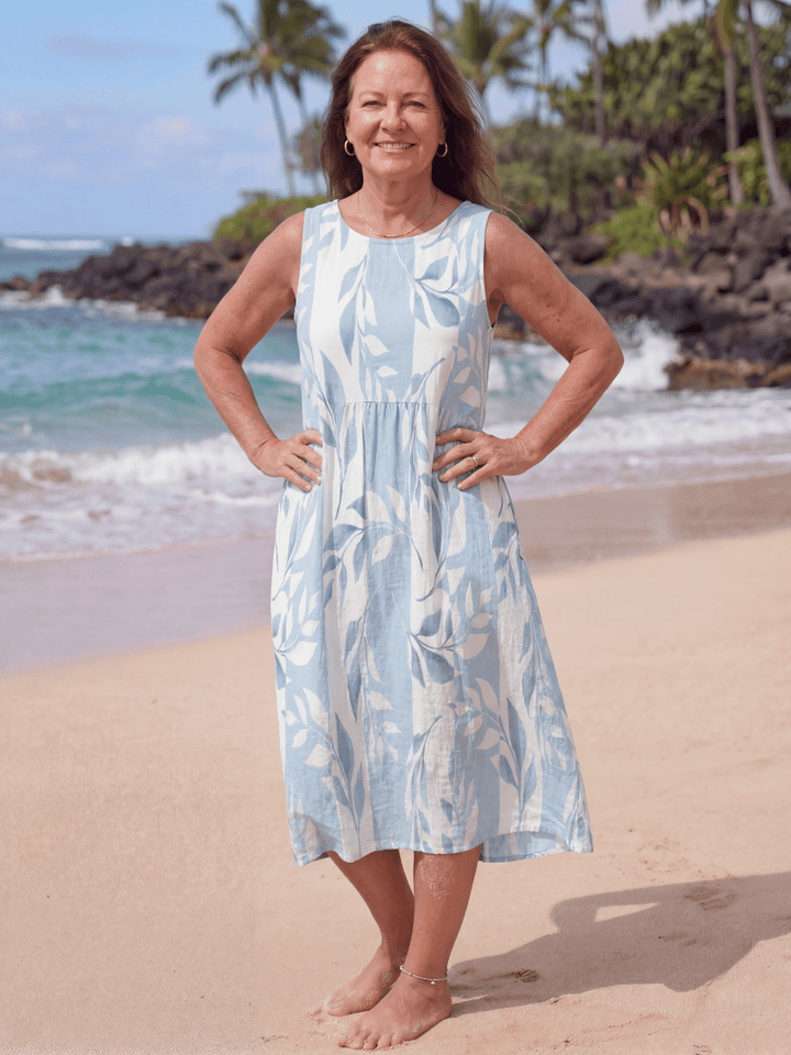 Kamilia™ Quiet Shore midi dress by Emma & Rose Cape Town, featuring a flowing fabric and elegant design, displayed on a hanger.