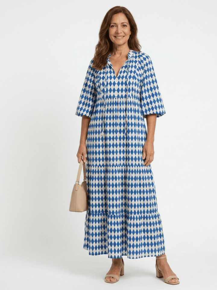 Elodie™ Print Tiered Midi Dress by Emma & Rose Cape Town, featuring a flowy, tiered design with a floral print and sleeveless style.