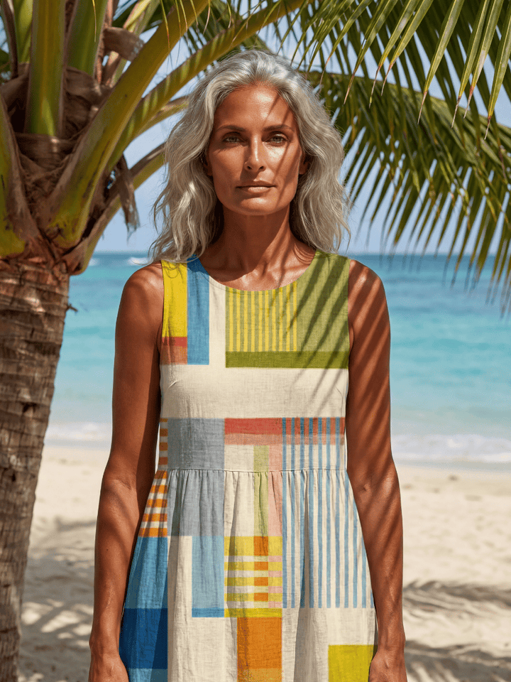 Emma & Rose Cape Town Esme™ Painted Block Midi Dress hanging on a wooden hanger, showcasing its colorful patterned fabric and midi length