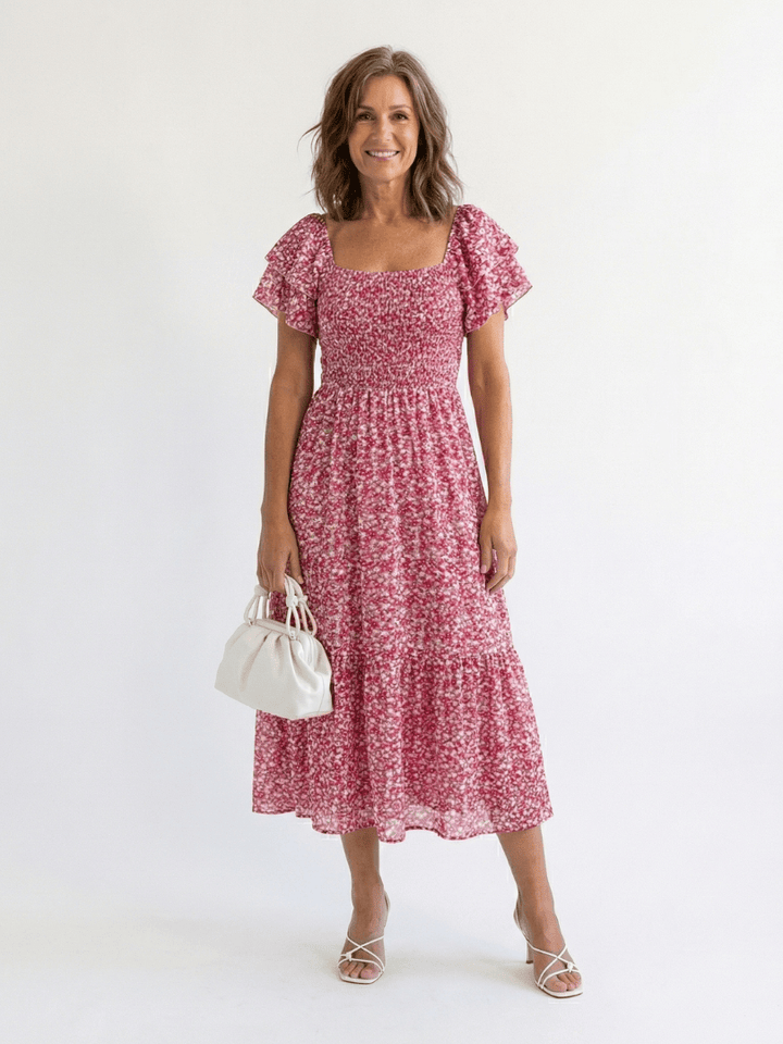 Odette™ floral smocked midi dress by Emma & Rose Cape Town, featuring a fitted bodice and flowing skirt with floral pattern.