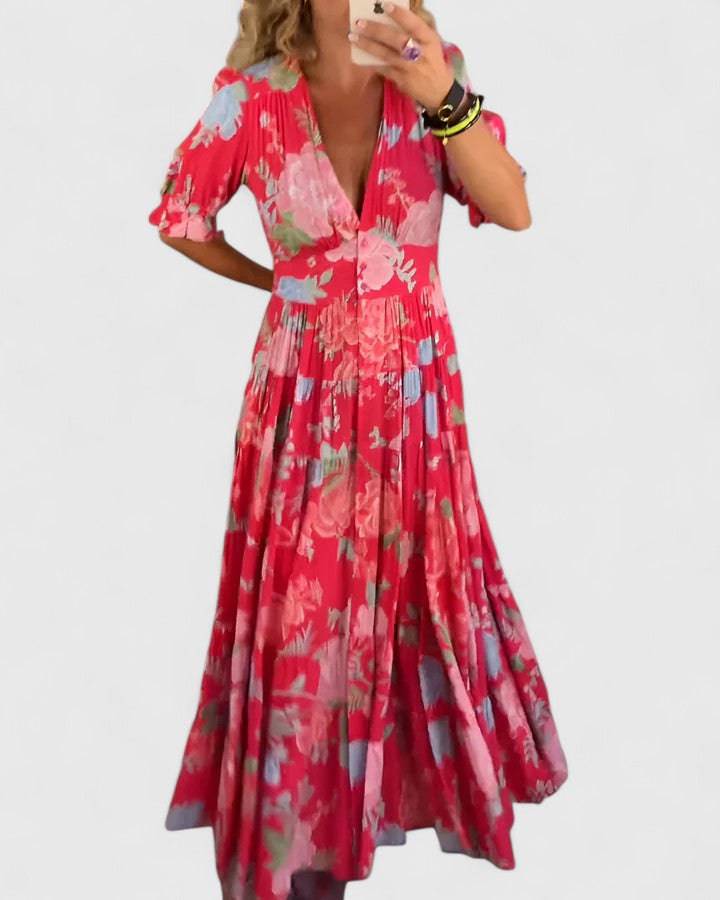 Elegant floral V-neck dress by Emma & Rose Cape Town featuring a fitted waist and flowing skirt, perfect for stylish occasions.