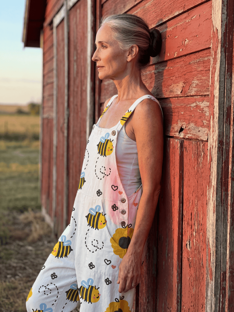 Emma & Rose Cape Town Moxie™ Bee Flower jumpsuit displayed on a hanger, featuring a colorful floral pattern and sleeveless design.