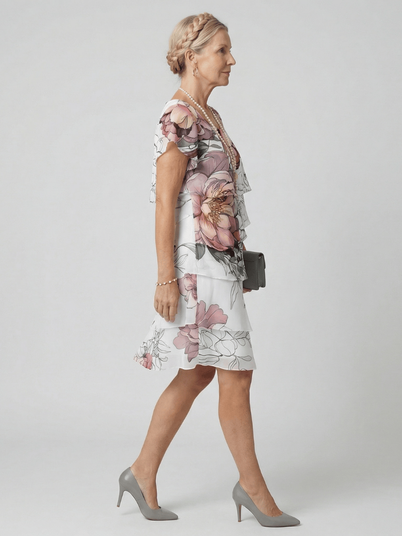 Kualani floral knee-length dress by Emma & Rose Cape Town featuring a vibrant botanical pattern and elegant fit.