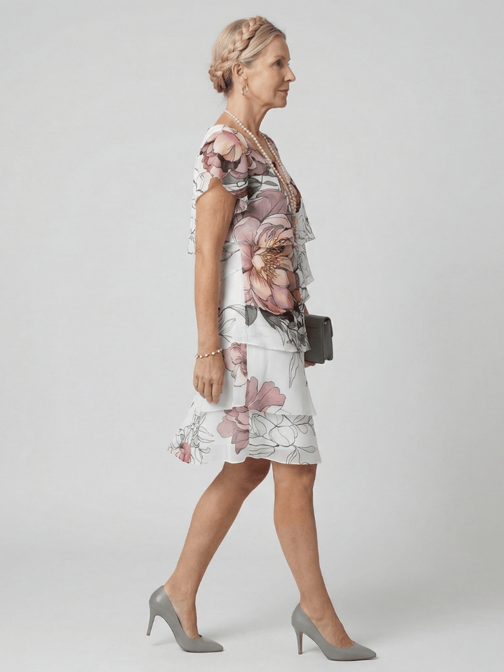 Kualani floral knee-length dress by Emma & Rose Cape Town featuring a vibrant botanical pattern and elegant fit.