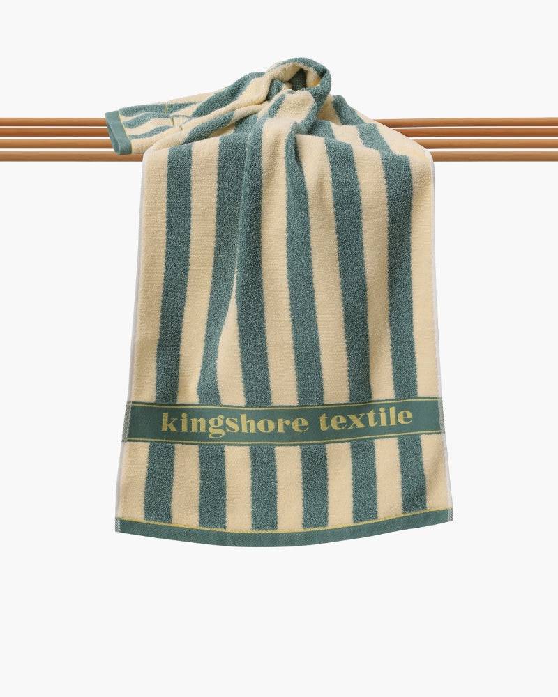 Emma & Rose Manhattan Lance™ Sea Stripe Hand Towel with blue and white striped pattern, soft fabric, and terry cloth texture.