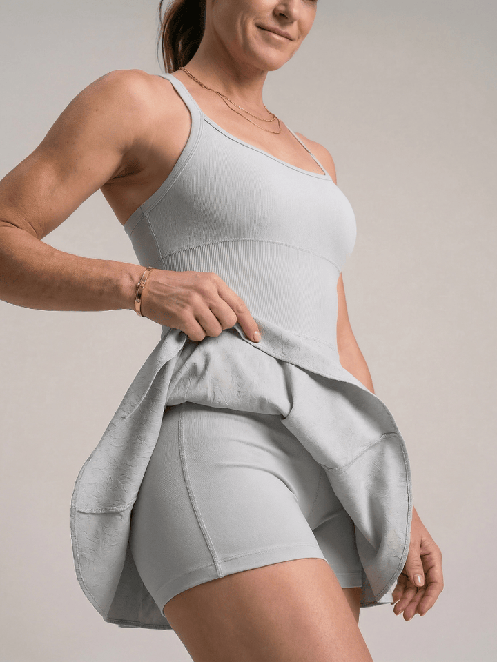 Emma & Rose Cape Town Zerelle™ strappy back tennis dress with fitted silhouette and stylish design, perfect for activewear and tennis.