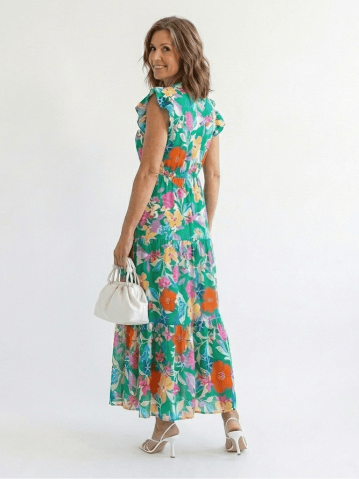 Lila™ V-neck tiered midi dress by Emma & Rose Cape Town, featuring flowing fabric and elegant layered design.