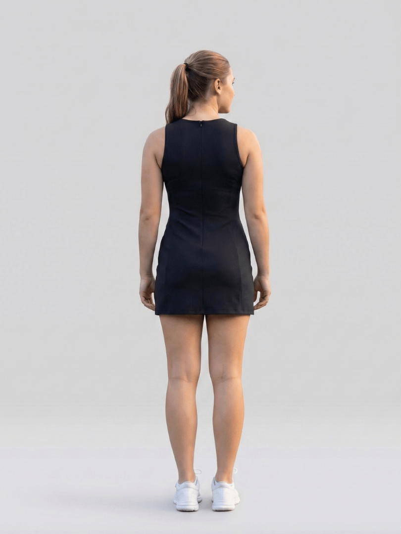 Fayen™ side slit tennis dress by Emma & Rose Cape Town, featuring a fitted design and stylish side slit, worn by a model outdoors.
