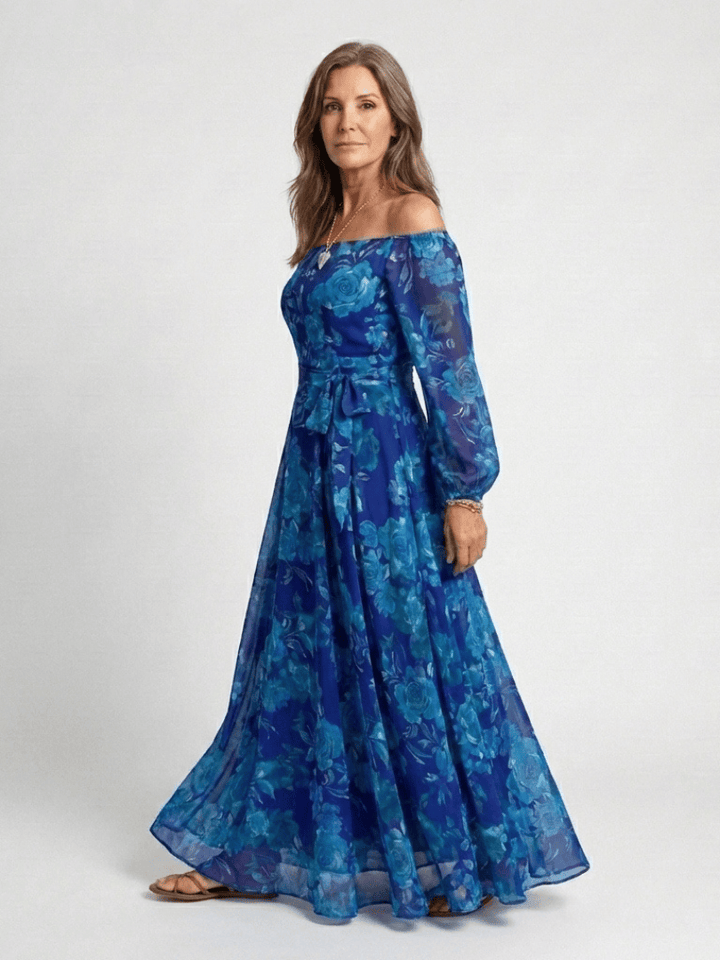 Aspen™ shoulder floral maxi dress by Emma & Rose Cape Town, featuring a vibrant floral pattern and flowy fabric.