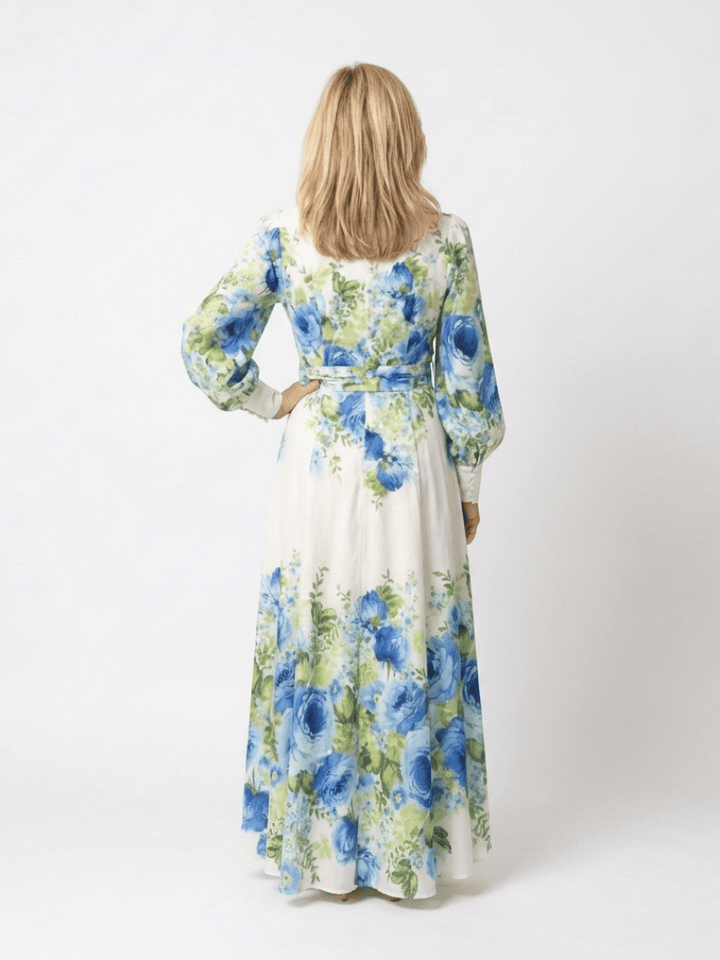 Emma & Rose Cape Town Harper™ button front maxi dress in floral fabric, flowing design with long sleeves and a fitted waist.
