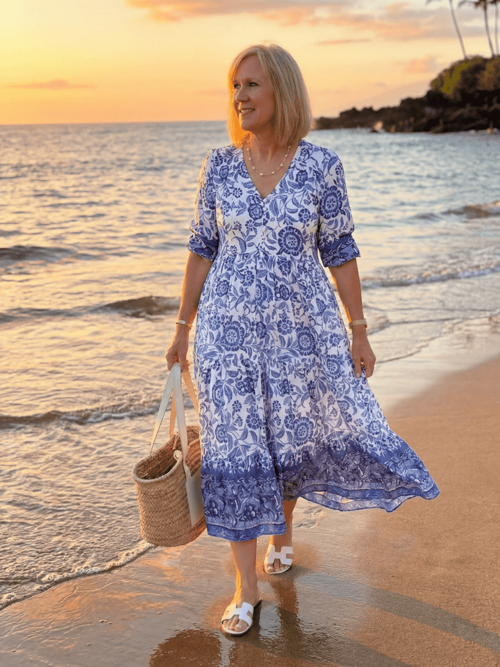 Emma & Rose Cape Town Nalani™ porcelain midi dress with floral pattern, elegant fit, and flowy fabric showcased in the image.