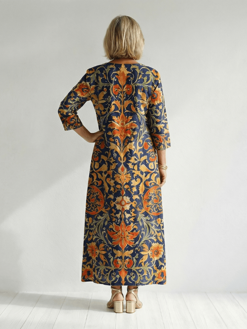 Emma & Rose Cape Town Elise™ ornate floral midi dress with a flowing fabric and intricate floral patterns on a model.