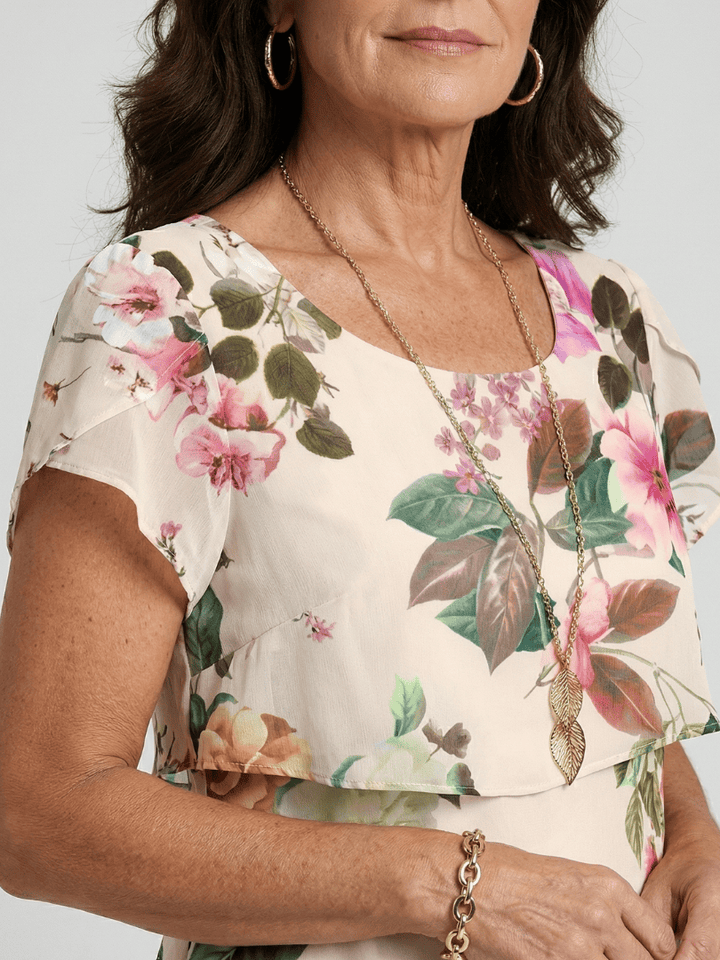 Silas™ Petal Knee Length Dress by Emma & Rose Cape Town featuring a floral pattern and a flowing, knee-length design.