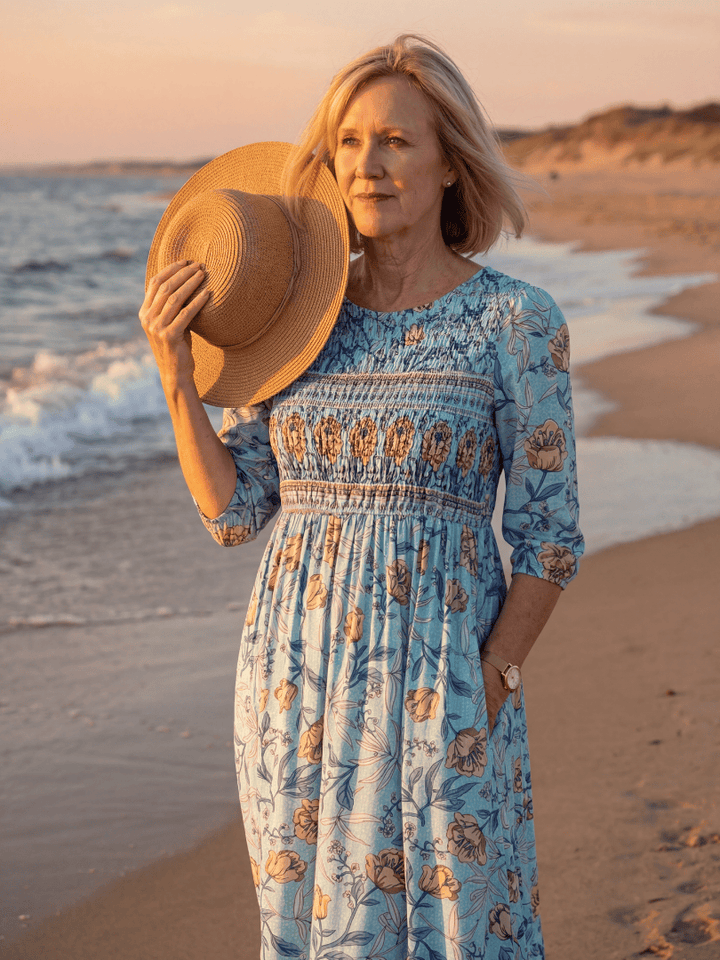 Emma & Rose Cape Town Halia Meadow Gather Midi Dress featuring floral print, flowing fabric, and midi length on a model.