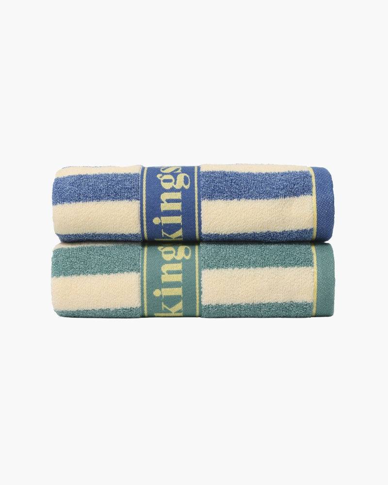 Emma & Rose Manhattan Lance™ Sea Stripe Hand Towel with blue and white coastal pattern, hanging on a towel rack.