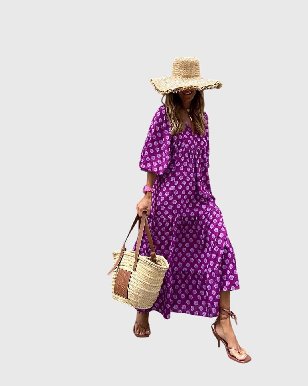 Sarah™ Boho Maxi Dress by Emma & Rose Cape Town, flowing fabric with floral prints, worn by a model outdoors in a natural setting.