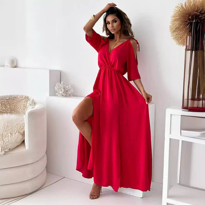 Long women's dress with off-shoulder design, elegant slit, and wrap neckline