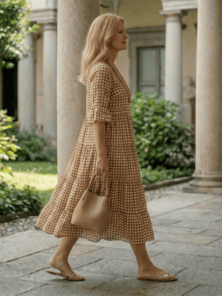 Emma & Rose Cape Town Arlo™ Dot Tiered Midi Dress featuring a playful dotted pattern and flowing tiered design.
