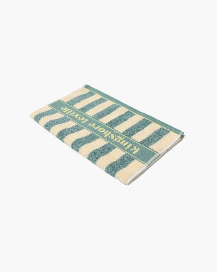 Emma & Rose Manhattan Lance™ Sea Stripe Hand Towel with blue and white nautical pattern, soft cotton fabric, hanging on a hook.