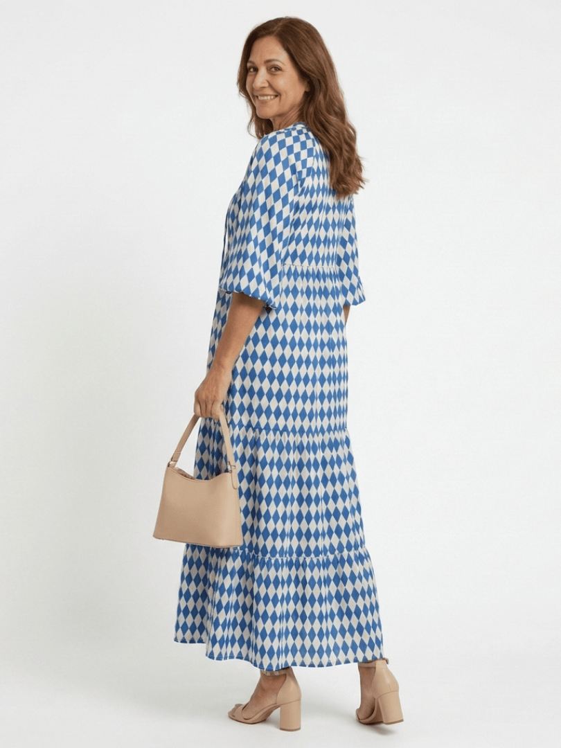 Elodie™ Print Tiered Midi Dress by Emma & Rose Cape Town, featuring a colorful floral pattern and tiered flowing fabric.