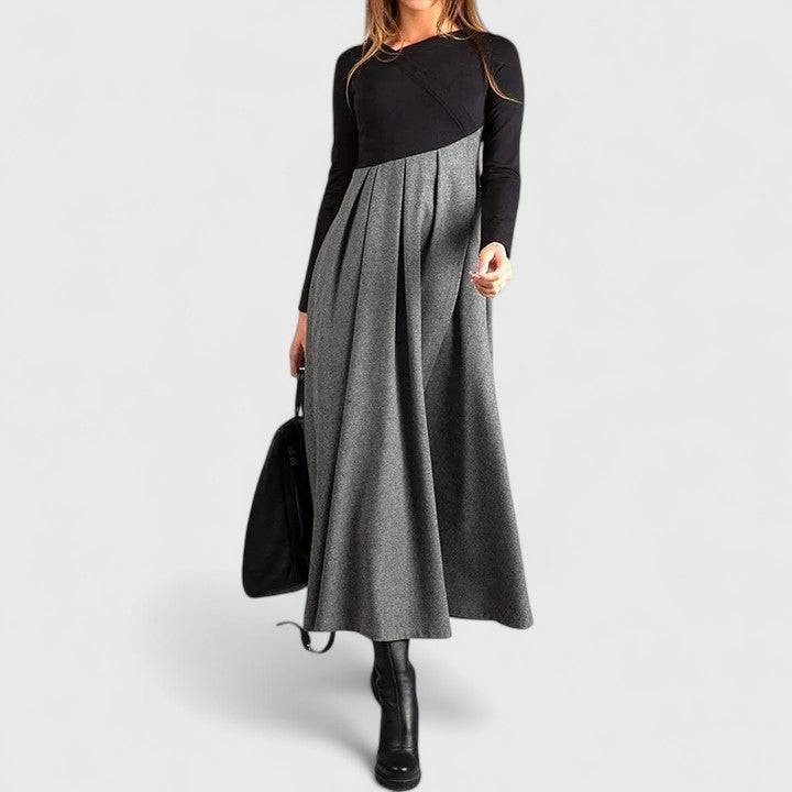 Emma & Rose Cape Town Janet™ long sleeve maxi dress in flowing fabric, featuring a fitted bodice and elegant floor-length design.
