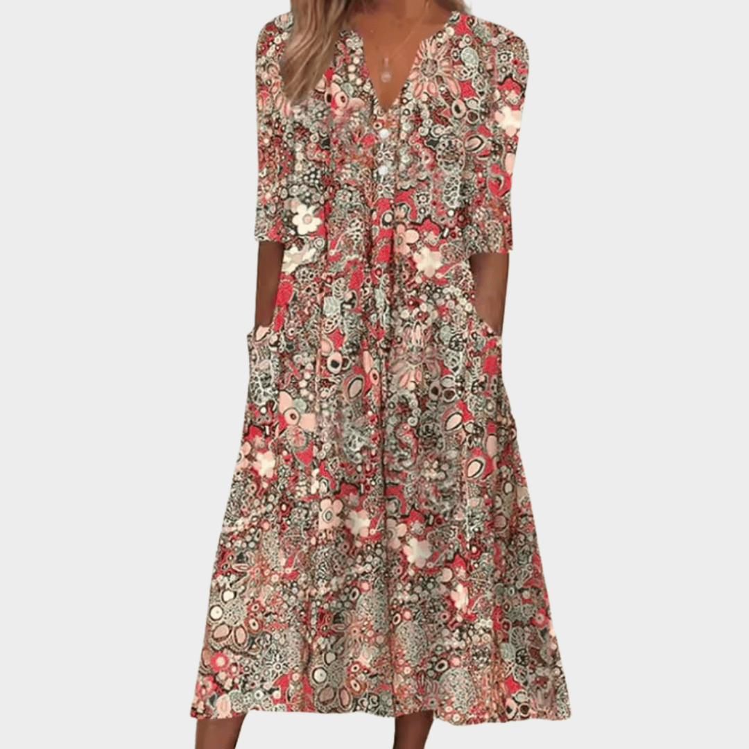 Queen™ elegant summer dress by Emma & Rose Cape Town, flowing fabric with floral pattern and sleeveless design.