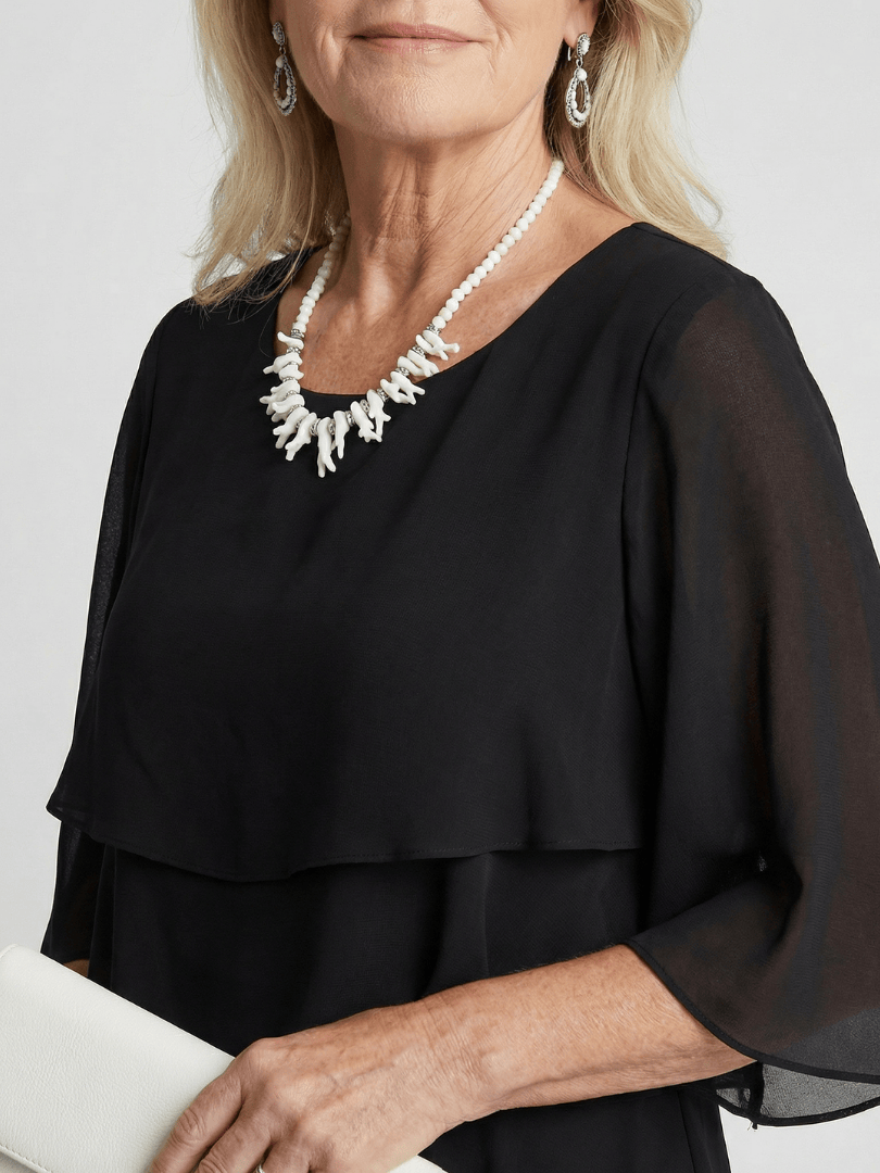 Emma & Rose Cape Town Brent™ layered tier midi dress showing a flowy, tiered design in soft fabric with a sleeveless silhouette.